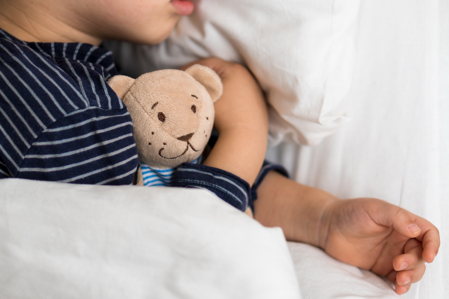 Child Hugging Teddy Bear While Sleeping 